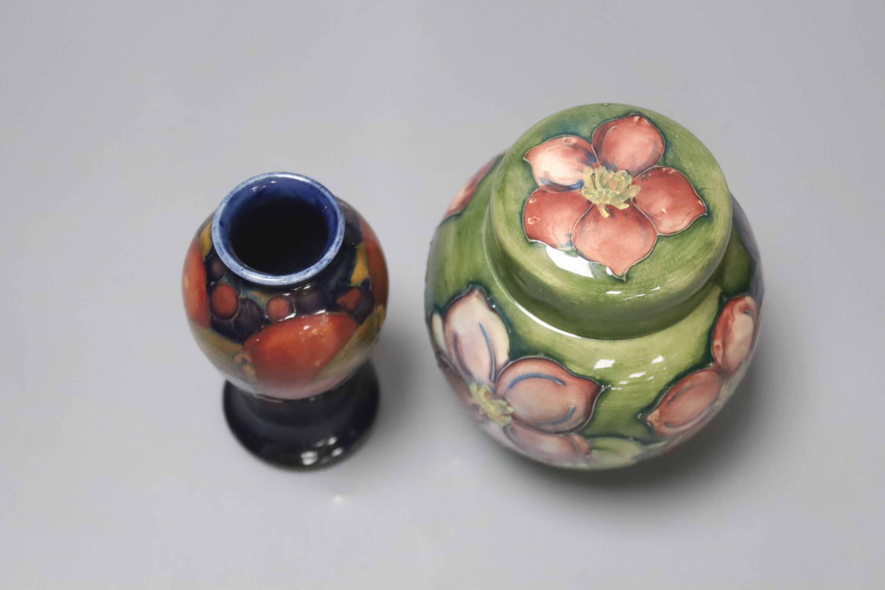 A Moorcroft Hibiscus jar and a similar Pomegranate vase, height 11cm